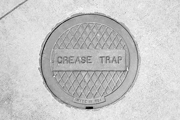 there are regulations that require regular grease trap pumping to prevent grease from entering the sewer system